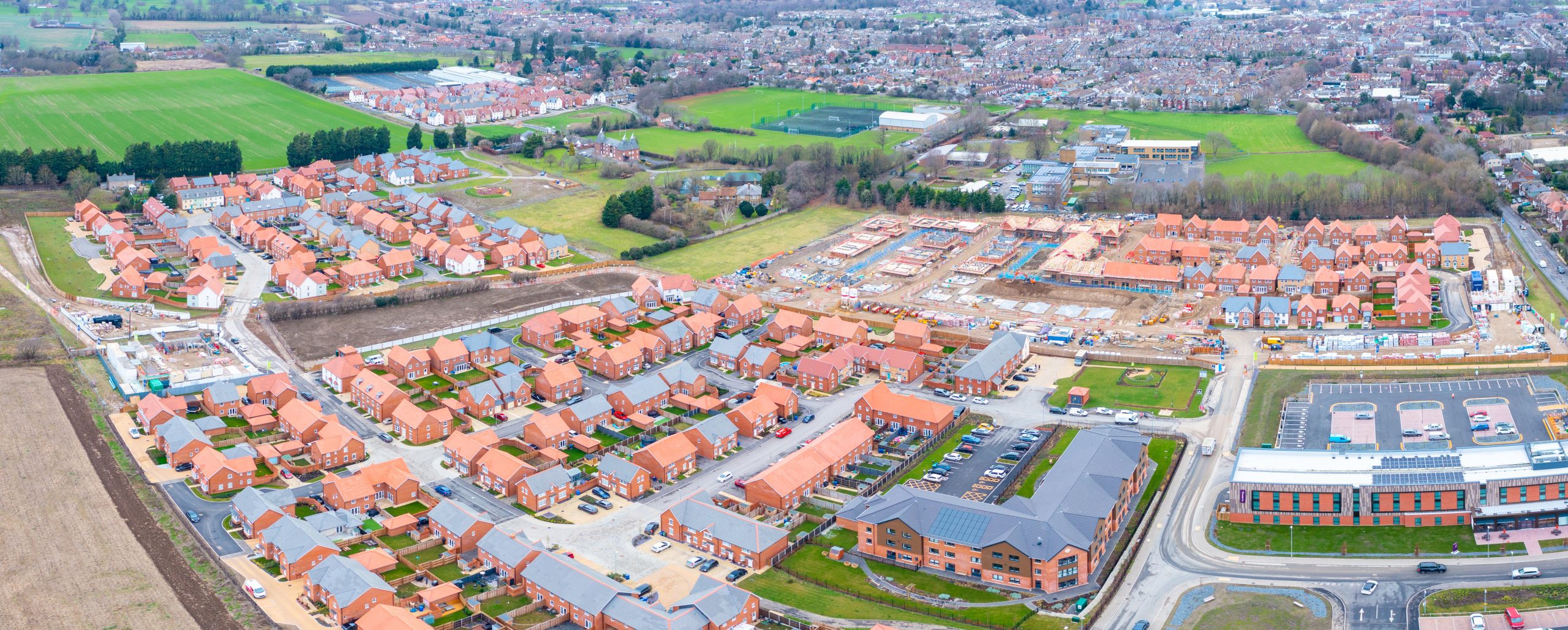 Development of new homes and a care home in Faversham on land promoted by Hallam Land. Aerial.