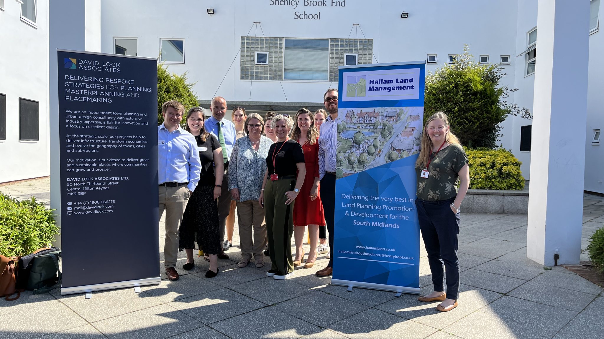 Hallam Land employees outside a school, showing students how land promoters work.